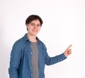 Young man nerd pointing finger aside at blank copy space, isolated on white grey studio background Royalty Free Stock Photo