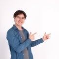 Young man nerd pointing finger aside at blank copy space, isolated on white grey studio background Royalty Free Stock Photo