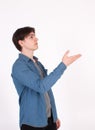 Young man nerd pointing finger aside at blank copy space, isolated on white grey studio background Royalty Free Stock Photo