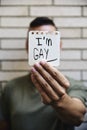 Young man with a note with the text I am gay Royalty Free Stock Photo