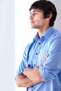 Young man, office and looking out window with arms crossed in thinking, confidence or contemplating. Face of handsome Royalty Free Stock Photo