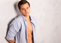 Young man in open shirt leaning against wall Royalty Free Stock Photo