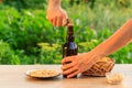 Young man opening bottle of beer with old opener Royalty Free Stock Photo