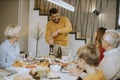 Young man opening bottle of red wine during at home Royalty Free Stock Photo