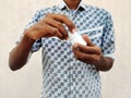 Young man opening a white jar of pills by hands. Royalty Free Stock Photo