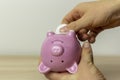 The young man opens the piggy bank.The concept of accumulating and saving money Royalty Free Stock Photo