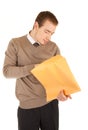 Young man opens a post package Royalty Free Stock Photo