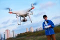 Young man operating of flying drone at sunset Royalty Free Stock Photo