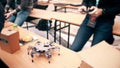 Young man operating his DIY hexapod robot using cell phone. 4K shot