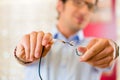 Young man at optician with glasses Royalty Free Stock Photo