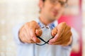 Young man at optician with glasses Royalty Free Stock Photo