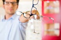 Young man at optician with glasses Royalty Free Stock Photo