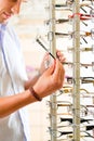 Young man at optician with glasses Royalty Free Stock Photo