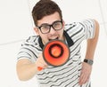 View from the top. a young man with orange megaphone,looking at the camera