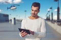 Young man ordering helicopter tour by tablet