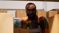 Young man organizing boxes in depot