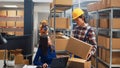 Young man organizing products boxes on racks Royalty Free Stock Photo