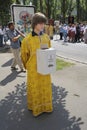 Young man orthodox monk standing on the street with donation box asking money for reconstruction of an old church. Kyiv