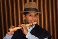 Young man from Otavalo, Ecuador, playing the quena flute