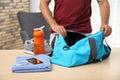 Young man packing sports bag Royalty Free Stock Photo