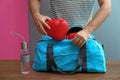 Young man packing sports bag Royalty Free Stock Photo