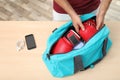 Young man packing sports bag Royalty Free Stock Photo