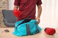 Young man packing sports bag Royalty Free Stock Photo