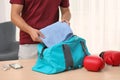 Young man packing sports bag Royalty Free Stock Photo