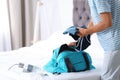 Young man packing sports stuff for training into bag Royalty Free Stock Photo