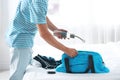 Young man packing sports stuff for training into bag Royalty Free Stock Photo