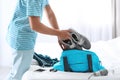 Young man packing sports stuff for training into bag Royalty Free Stock Photo