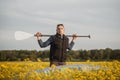 A young man with a paddle and sup Board in a rapeseed field Royalty Free Stock Photo