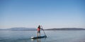 Young man paddling on a sup board Royalty Free Stock Photo