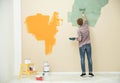 Young man painting wall indoors. Home repair Royalty Free Stock Photo