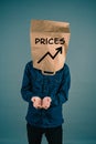 Young man with paper bag on his head, increasing prices, open hands begging for money, finacial crisis, poverty Royalty Free Stock Photo