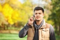 Young man in park speaking on the smartphone