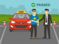 Young man passes his practical driving test. Examiner congratulates and shaking driver`s hand.