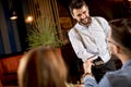 Young man paying with contactless credit card in the restaurant Royalty Free Stock Photo