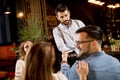 Young man paying with contactless credit card in the restaurant Royalty Free Stock Photo