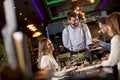 Young man paying with contactless credit card in the restaurant Royalty Free Stock Photo