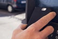 Young man paying with his smartphone in a parking meter Royalty Free Stock Photo