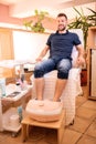 Young man in a pedicure salon