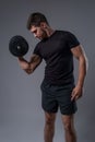 Young man performing one arm bicep curl with dumbbell Royalty Free Stock Photo