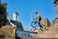 Young man performing a radical mountain bike jumps in old town