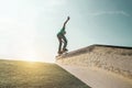 Young man performing with skateboard up ramp at sunset in urban city park - Skater having fun with back sunlight - Extreme sport, Royalty Free Stock Photo