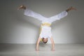 Young man performs a handstand, capoeira. Royalty Free Stock Photo