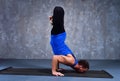 Young man performs Urdhva padma vrikshasana