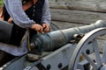 Young man in period dress, loading gunpowder into canon,Fort William Henry,Lake George,New York,2015 Royalty Free Stock Photo