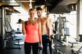 Personal trainer helping woman to working out in gym. Healthy lifestyle sport people concept Royalty Free Stock Photo