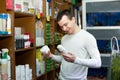 Young man with pet supplements in petshop